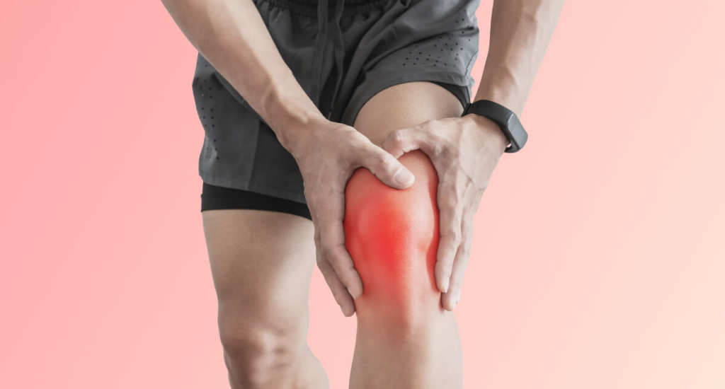 A person in athletic wear holds their knee, which has a glowing red overlay indicating pain or inflammation. A fitness tracker is visible on their wrist.