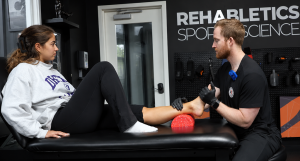 Sports physical therapist providing sports injury rehabilitation treatment to an athlete in South Jersey, NJ
