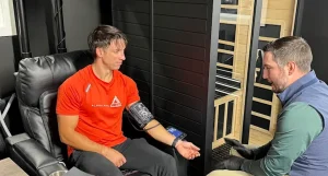 Athlete consulting a sports physical therapist for injury evaluation and treatment