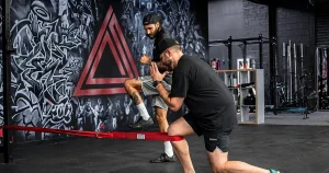 Physical therapist guiding an athlete through ACL rehab exercise at Rehabletics in Cherry Hill