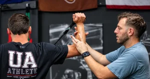 Physical therapist guiding a pitcher through elbow rehab after Tommy John surgery