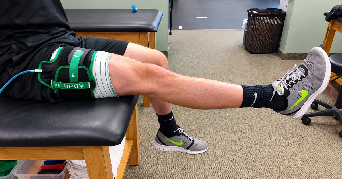 Patient building quad strength with a blood flow restriction cuff before ACL surgery