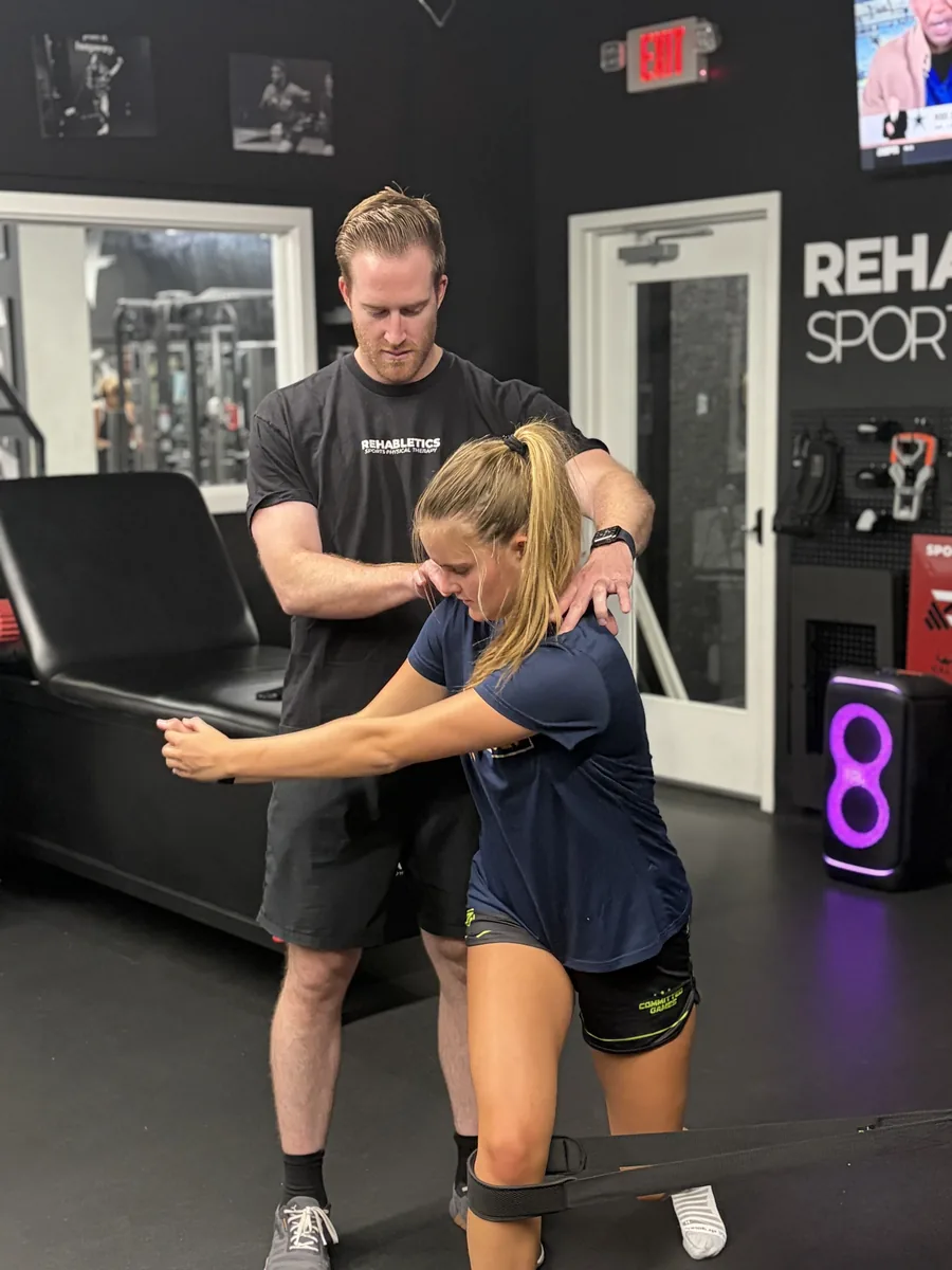Dr. Erik Bonn guiding a female athlete through hip and trunk rotation training