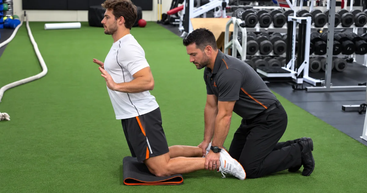 Soccer player doing Nordic hamstring curls to reduce hamstring strain risk