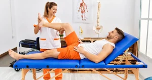 Physical therapist examining an athlete's inner knee for an MCL sprain