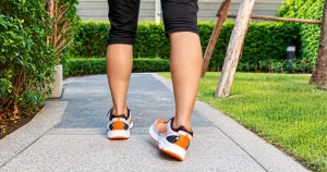Runner experiencing an ankle roll on a flat paved path